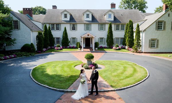 a bride and groom infront of the royalton mansion