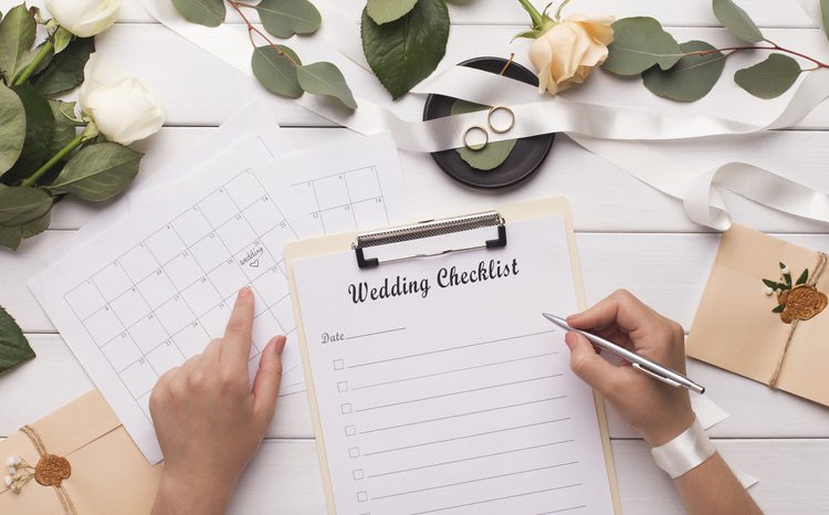 Woman writing wedding items in checklist for planning budget, panorama
