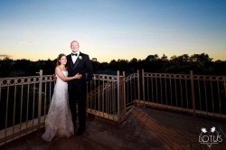 a bride and groom on a balcony
