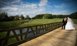 a bride and groom on a bridge