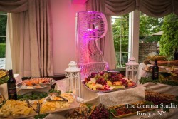 an ice sculpture infront of a variety of food