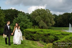a bride and groom surrounded by greenery