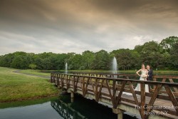 a bride and groom on a bridge