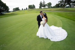 a bride and groom kissing on a golf course