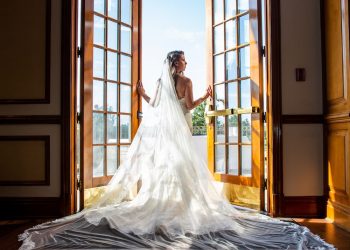 a bride through a double glass door