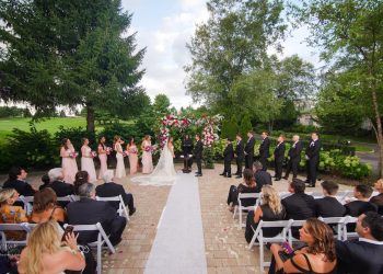 an outdoor wedding ceremony, full view of the wedding party