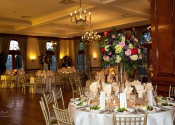 a wedding reception area, with tables set up with floral centerpieces