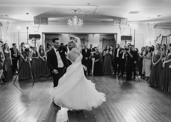 a black and white photo of a bride and groom on the dance floor