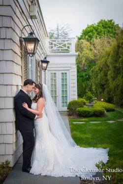 a bride and groom leaning on the side of the royalton mansion