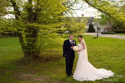 a bride and groom taking a photo outside, infront of the royalton mansion