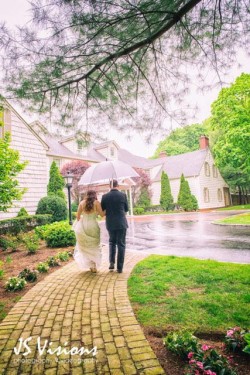 a bride and groom walking on a path to the royalton mansion