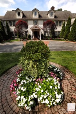 a front shot of the royalton mansion, with flowers