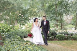 New York wedding photography by A Day of Bliss Photography Inc. New York. a bride and groom walking down a path