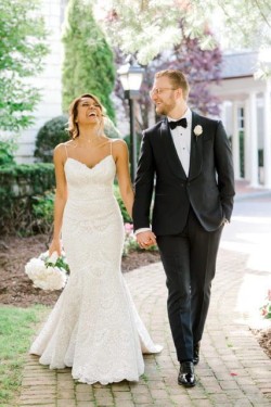 a bride and groom walking down a path from the royalton mansion