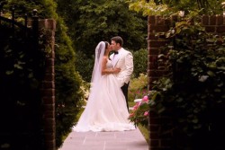 a bride and groom outside, kissing